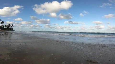 Low angle of the tide coming in coming right up around the camera Stock Footage 146391397