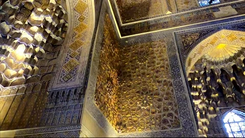 Low angle tilt up and pan left of golden walls and dome in Gur-e-Amir interior Stock Footage 336188052