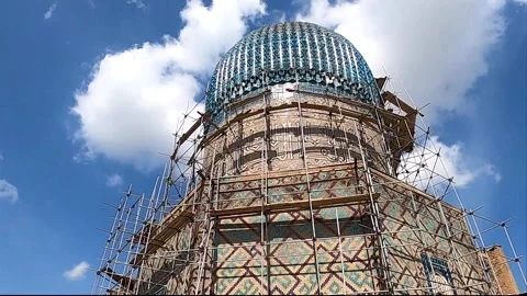 Low angle tilt up of Gur-e-Amir Mausoleum facade under restoration, Samarkand Stock Footage 336188076