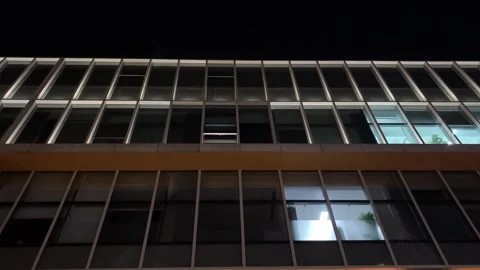 Low Angle Tilt Up of Modern Office Building at Night with Illuminated Windows Stock Footage 333472256