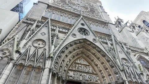 Low Angle Tilt Up of Notre Dame Cathedral Facade in Paris Stock Footage 335498385