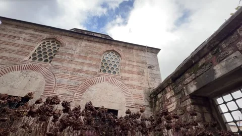 Low angle tilt shot brickwork and honeycomb arched windows of a Ottoman-era Stock Footage 340155120