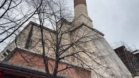 Low angle tilt shot stone minaret and mosque architecture framed by bare Vídeos de archivo 340155140