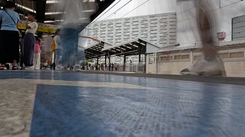 Low Angle Time Lapse of Commuters on Train Station Platform in Osaka, Japan Stock Footage 337909041