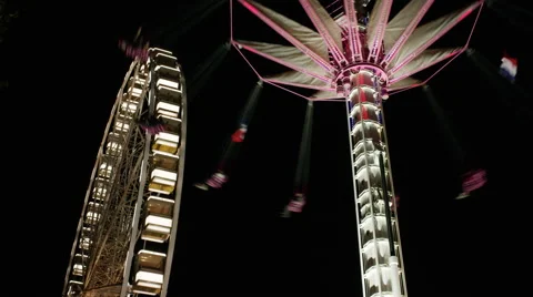Low angle time lapse view of illuminated carnival rides at night / Paris, France Stock Footage 43628429
