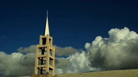 Low angle timelapse clip of church steeple with large billowing clouds Stock Footage 45296320