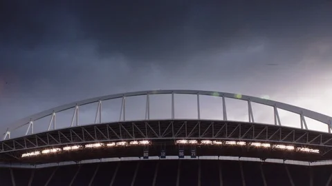 Low angle timelapse view of clouds moving over stadium at sunset Stock Footage 104773643