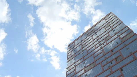 Low Angle Timelapse View On white clouds over high building Stock Footage