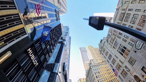 Low-angle of towering skyscrapers and luxury storefronts on Fifth Avenue, NYC Stock Footage 302864132