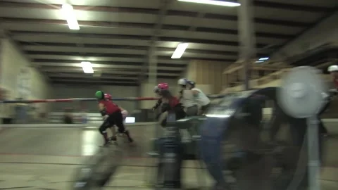 Low angle of track as skaters compete during training, Texas Roller Derby Video stock 232957993