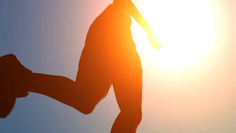 Low Angle Tracking Shot of Female Jogging in Sunshine Video stock 72687427