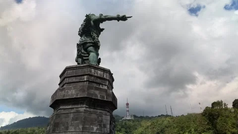 Low Angle Tracking Shot of Kumbhakarna Statue in Bali Against Cloudy Sky Stock Footage 339333791