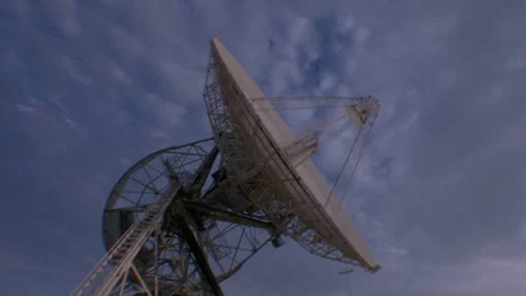 Low angle tracking shot of a large satellite dish Stock Footage 312274091