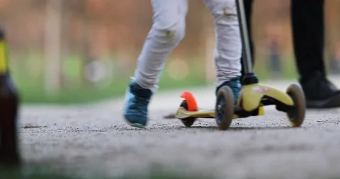 Low Angle Tracking Shot of Male Female Kids Feets in the Park Stock Footage 126756551