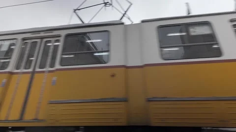 Low angle: Transit train rolls past Parliament Building in Budapest Stock-Footage 297875353
