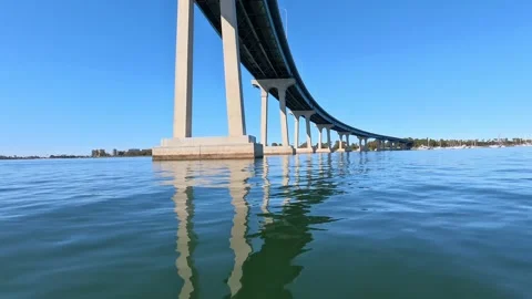 Low Angle Under Coronado Bridge San Diego Water Reflection Clear Blue Sky Stock Footage 331614349