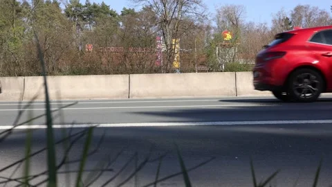 Low angle under guardrail with vehicles rushing past Video stock 331188772