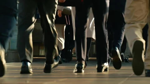 Low angle of unrecognized crowd of people walking in the street. Slow motion. Stock Footage 262630391