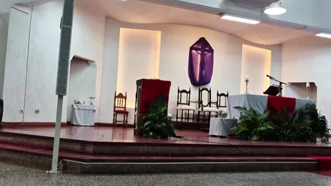 Low angle upward camera movement revealing covered cross in Catholic church Video stock 332248983