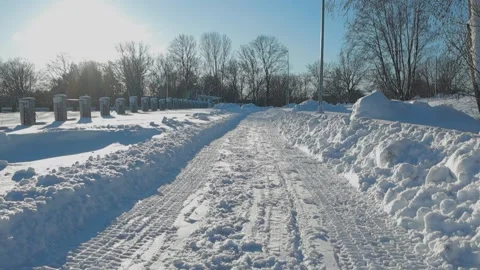 Low angle upward panning footage of a pedestrian white snow covered road during Stock Footage 299832253