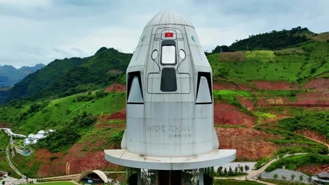 Low angle upward view of rocket shaped glass elevator in Moc Chau 4K Stock Footage 337149427