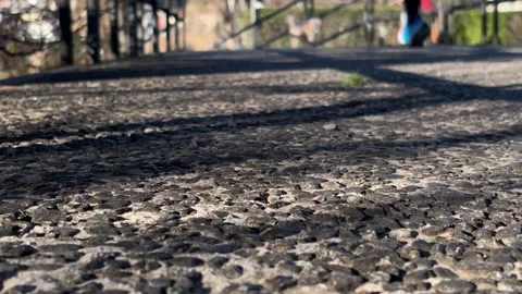 Low angle urban running with shallow depth of field and blurred jogger Stock Footage 328941128