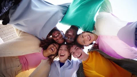 Low angle. Vertical. A group of multiracial young friends wearing colorful Stock Footage 271602819