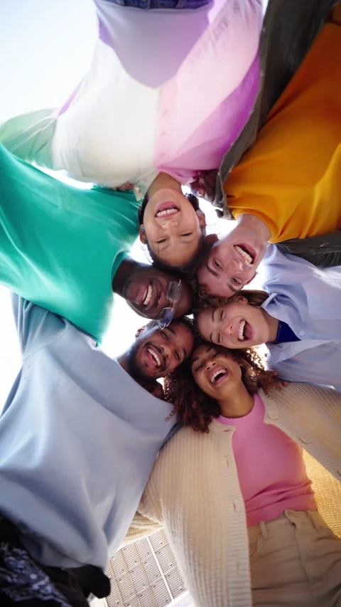 Low angle. Vertical. A group of multiracial young friends wearing colorful Stock Footage 272835314