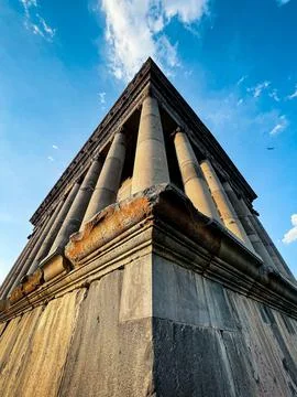 Low angle vertical shot of an ancient Hellenic temple built on a solid stone fou 스톡 사진