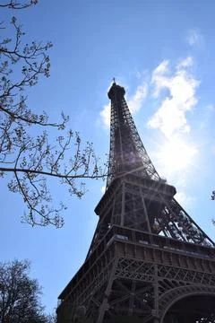 Low-angle vertical shot of Eiffel Tower in Paris, France against a blue sky Stock Photos