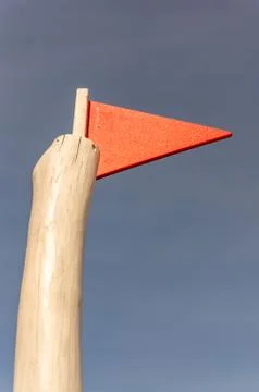 Low angle vertical shot of a red triangular flag 스톡 사진