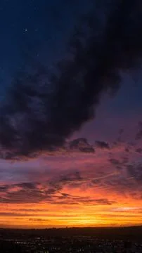 Low angle vertical shot of the sky during sunset with the stars visible Foto stock