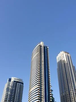 Low angle vertical view of modern glass skyscrapers against a blue sky Stock Photos