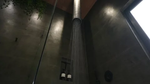 Low angle vie of water streaming from extraordinary shower head in bathroom with Stock Footage 259714996