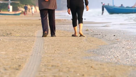 Low angle view of 2 lady walking along the beach Stock Footage 73608441