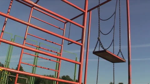 Low angle view on abandoned playground filmed on a sunny summer evening Stock Footage 233464759