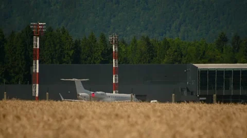 Low angle view of airplane and hangar in the distance Stock Footage 161100944
