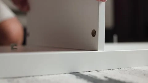 Low Angle View Aligning Shelf Panel onto Screw Video stock 344145771
