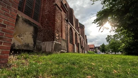 Low Angle View Along Historic Brick Church Wall in Sunlight Stock Footage 340505756