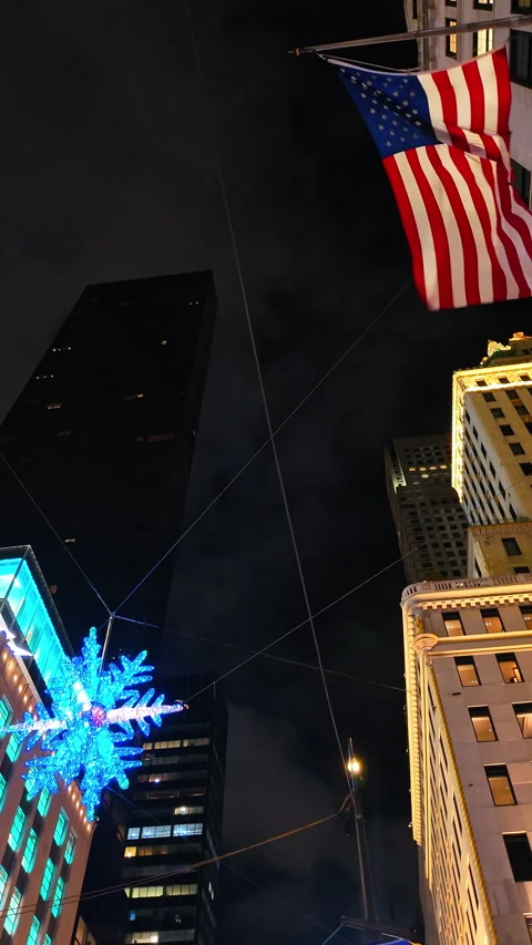 Low angle view of American flag and holiday snowflake. Upward perspective of a Stock Footage 330389890