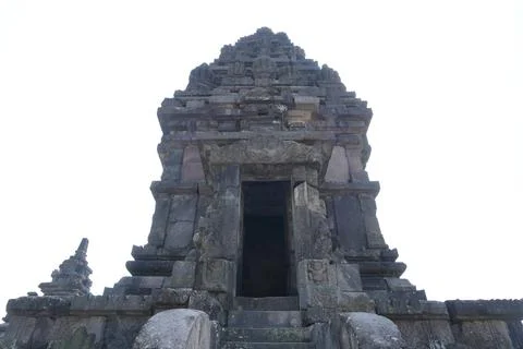 A low-angle view of an ancient Hindu stone temple tower. Stock Photos