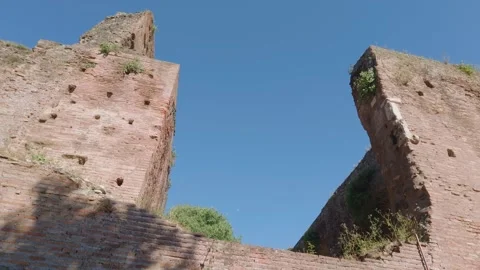 Low Angle View of Ancient Roman Brick Ruins Against Blue Sky in the Roman For Video stock 338175347
