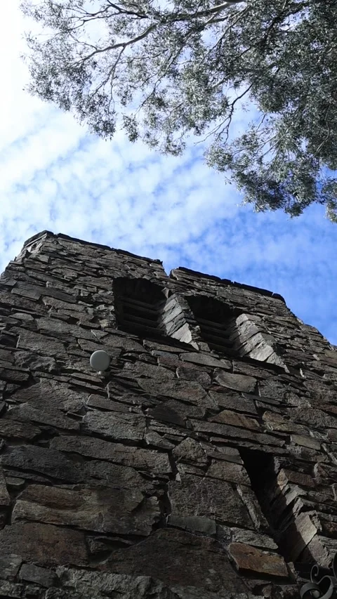Low angle view of an ancient stone tower against blue sky Stock Footage 341906414