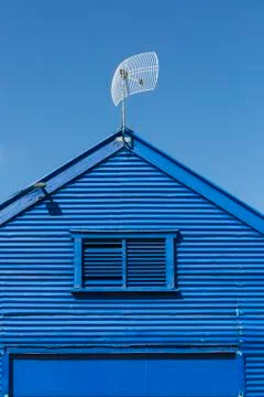 Low angle view of antenna on blue church against clear sky Ilustración de archivo