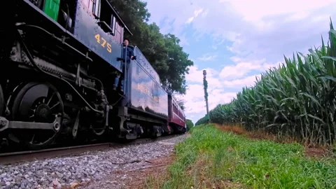 Low Angle View of an Approaching Steam Engine Blowing Smoke Stock Footage 143522959