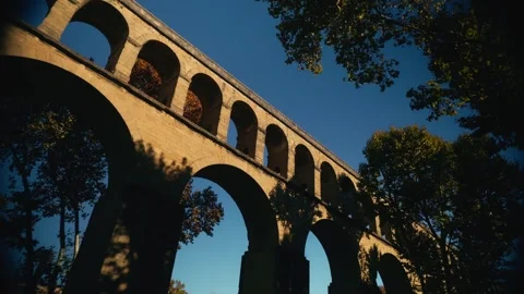Low angle view of aqueduct arches through trees Stock Footage 331229120