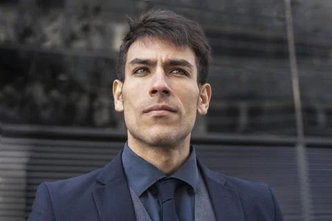 Low-angle view of an attractive executive man looking away. Stock Photos