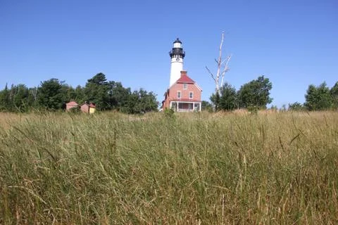 Low angle view of Au Sable Lighthouse, through the grass Stockfoto's