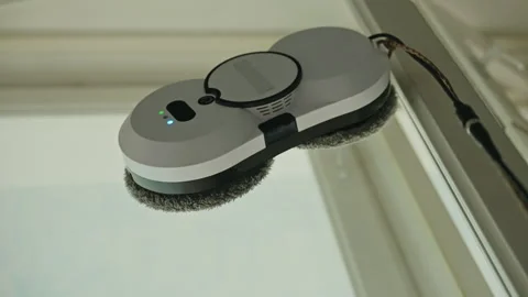 Low-angle view of automatic window cleaning robot efficiently washing large Stock Footage 312233656