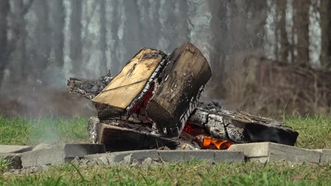 Low Angle View of a Backyard Campfire Burning in a Stone Pit Stock Footage 345007503